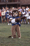 Lucky the Lion Holding Cheerleader by East Texas State University