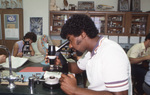 Student with Microscope by East Texas State University