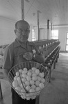 Jimmie D. Wolf with Basket of Eggs by East Texas State University