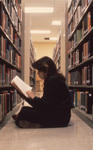 Student Reading in Library by East Texas State University