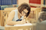 Student Writing In Library by East Texas State University