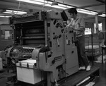 Person Operating Printing Press by East Texas State University